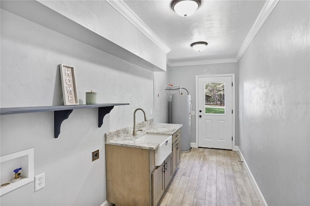 laundry room with electric water heater, hookup for a washing machine, hookup for an electric dryer, ornamental molding, and sink