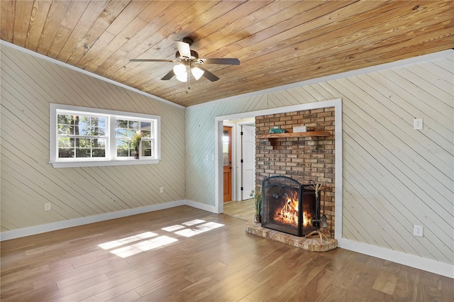 unfurnished living room featuring light hardwood / wood-style floors, wood ceiling, and wooden walls