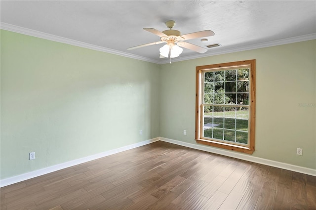 empty room with ceiling fan, crown molding, and hardwood / wood-style flooring