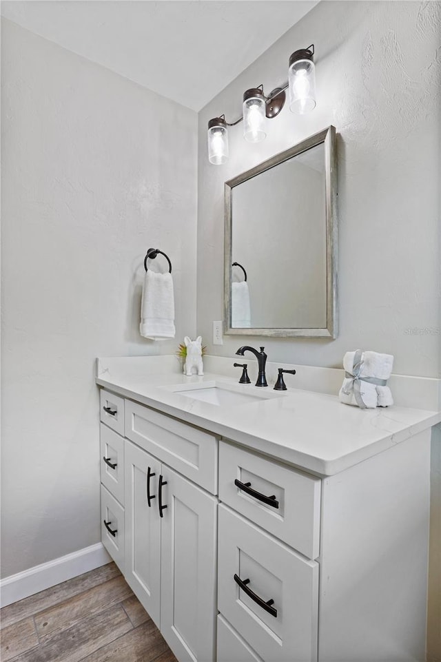 bathroom with hardwood / wood-style floors and vanity