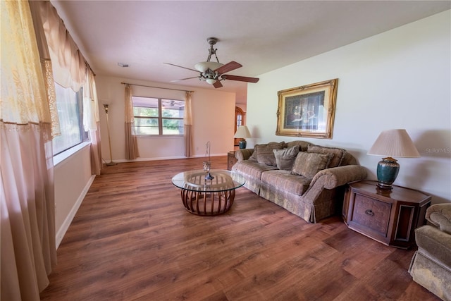 living room featuring ceiling fan and dark hardwood / wood-style flooring