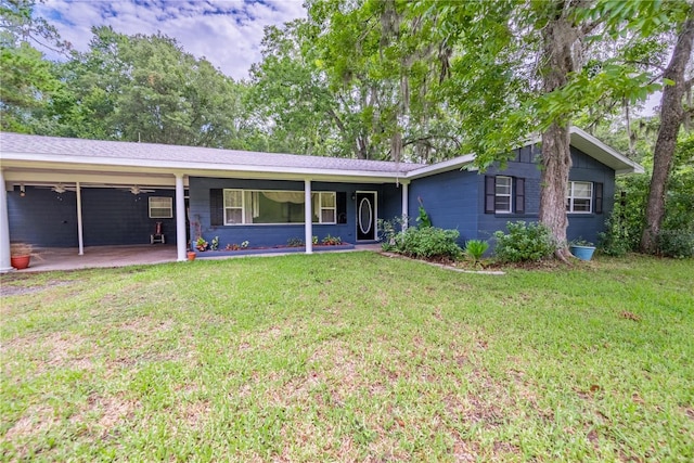 single story home with a front yard and a carport