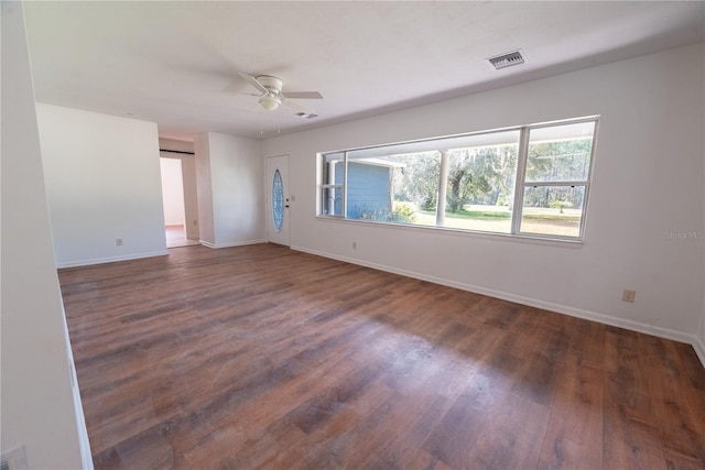 unfurnished room with dark wood-type flooring and ceiling fan