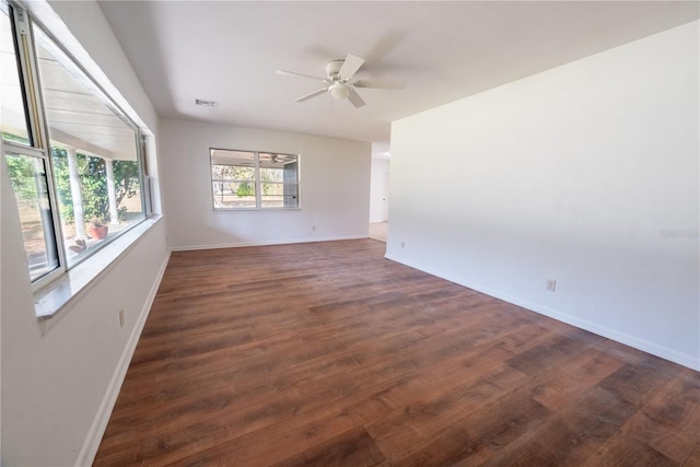 spare room with ceiling fan and dark hardwood / wood-style floors