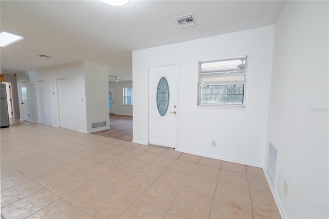 tiled entryway with ceiling fan