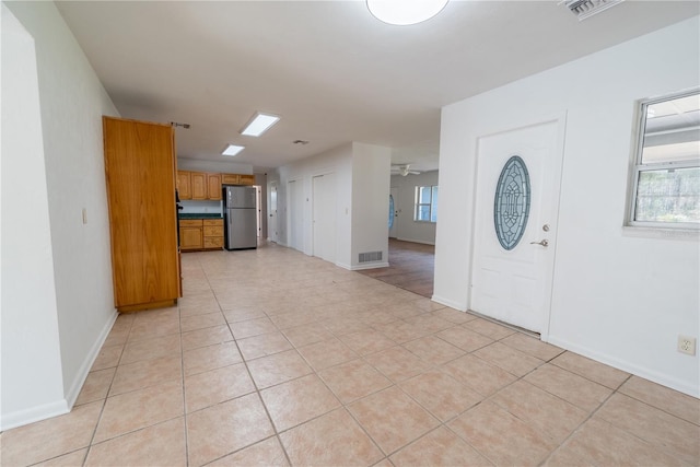 tiled entrance foyer featuring ceiling fan and plenty of natural light