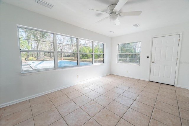 unfurnished sunroom with ceiling fan