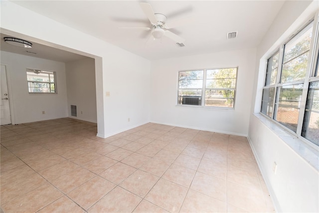 tiled spare room featuring ceiling fan