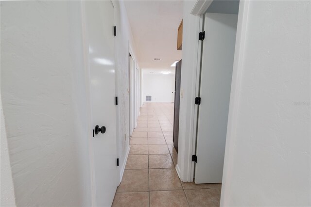 corridor with light tile patterned floors