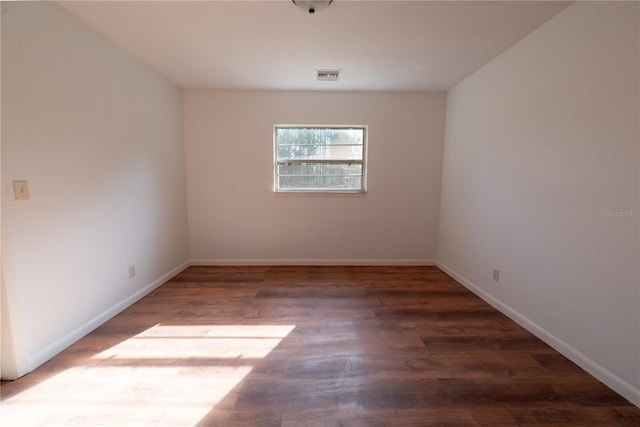 spare room featuring dark hardwood / wood-style flooring