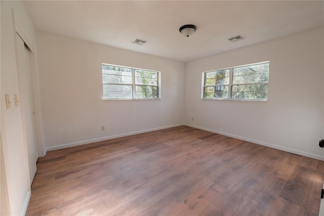 unfurnished bedroom featuring hardwood / wood-style flooring and a closet