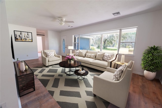 living area with wood finished floors, a ceiling fan, visible vents, and baseboards