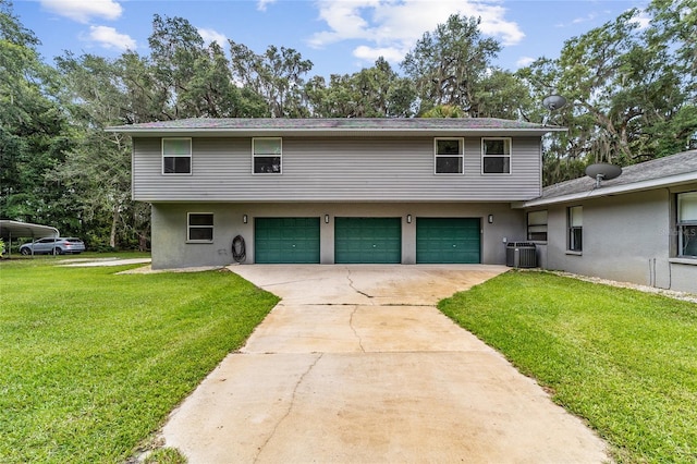 view of front facade with a front yard, a garage, and cooling unit