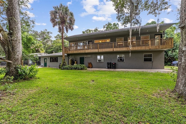 rear view of property featuring a yard and a deck