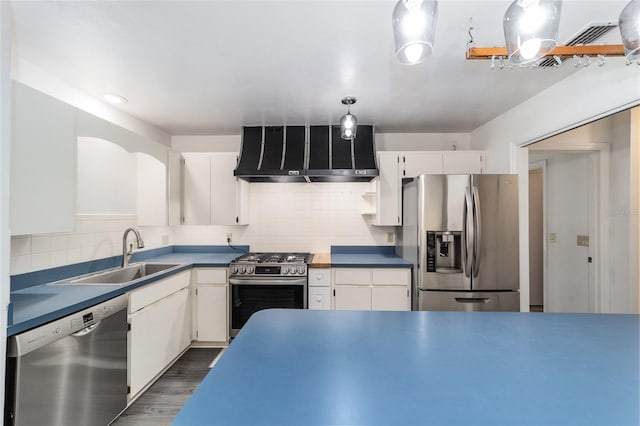 kitchen featuring white cabinets, appliances with stainless steel finishes, and wall chimney range hood