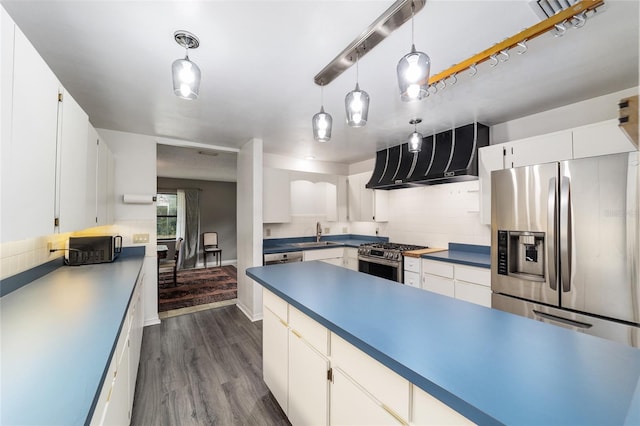 kitchen featuring decorative backsplash, appliances with stainless steel finishes, decorative light fixtures, and white cabinetry