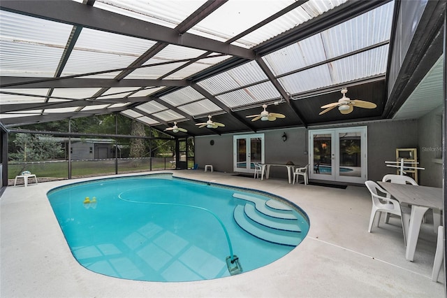 view of pool featuring french doors, a lanai, and a patio area