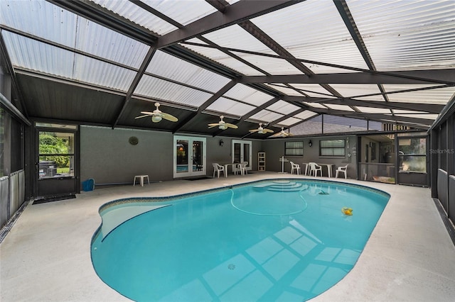 view of pool featuring glass enclosure, ceiling fan, french doors, and a patio area