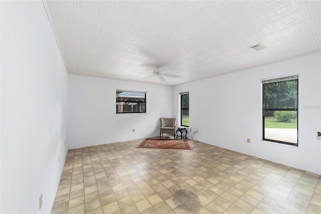 unfurnished room with a wealth of natural light and ceiling fan