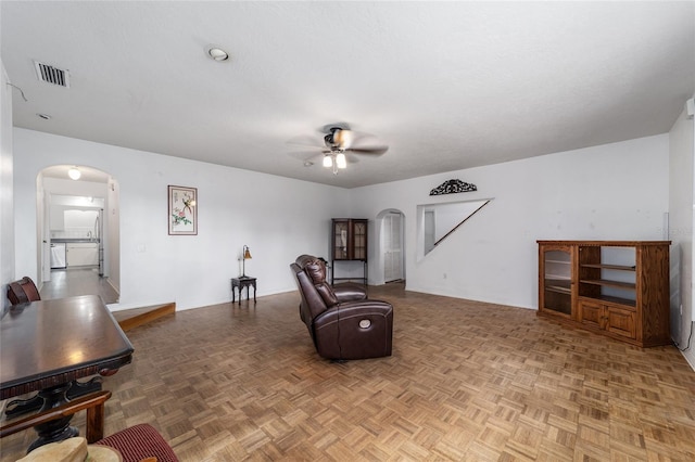 sitting room with parquet flooring and ceiling fan