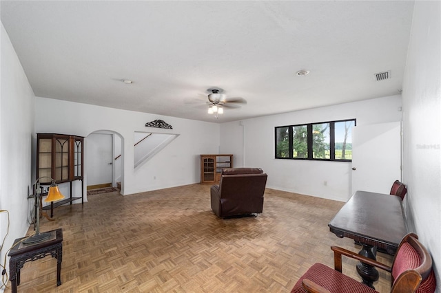 interior space featuring ceiling fan and parquet floors