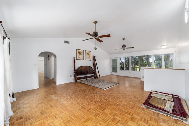 unfurnished living room with ceiling fan, lofted ceiling, and light parquet floors