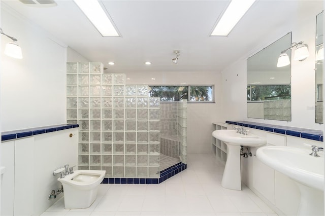 bathroom featuring a bidet, double sink, tile walls, and tiled shower