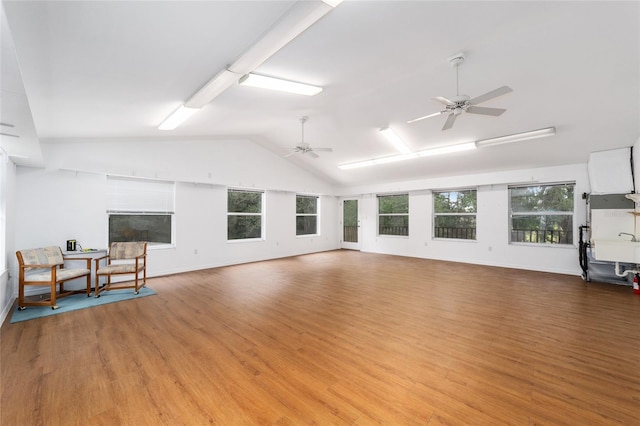 living room featuring light hardwood / wood-style floors and vaulted ceiling