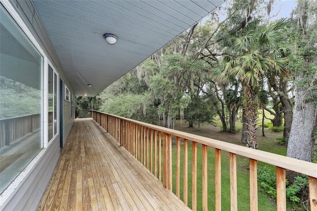 wooden deck featuring a lawn