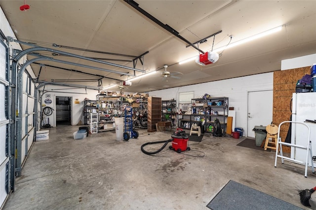 garage with ceiling fan, a garage door opener, and white refrigerator