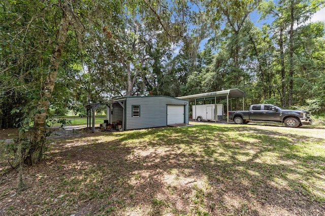 view of yard with a carport and an outdoor structure