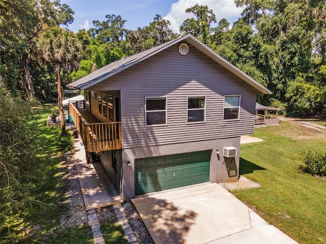 view of front of home featuring a wall mounted AC, a front lawn, a deck, and a garage