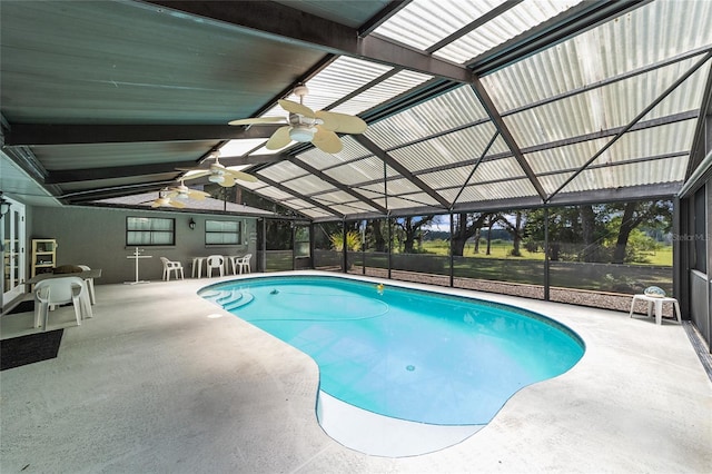 view of swimming pool with glass enclosure, a patio area, and ceiling fan