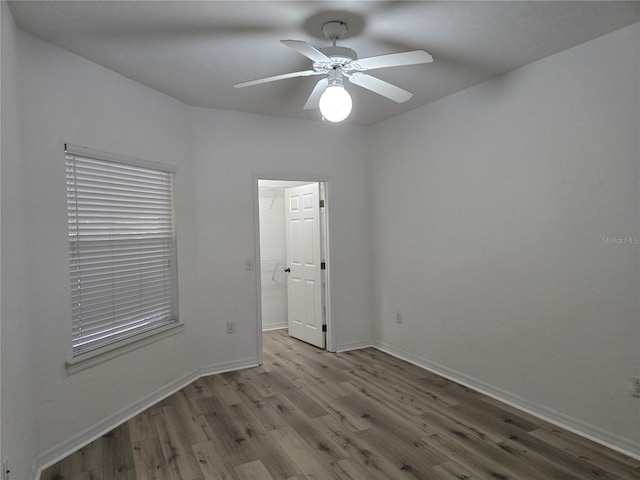 spare room with ceiling fan and light wood-type flooring