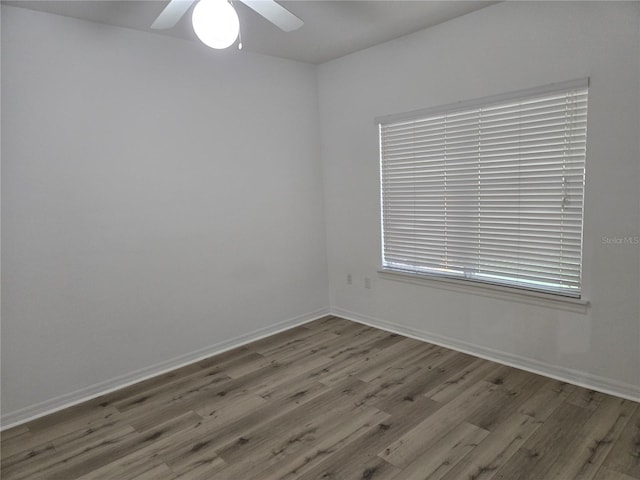 unfurnished room with hardwood / wood-style floors and ceiling fan