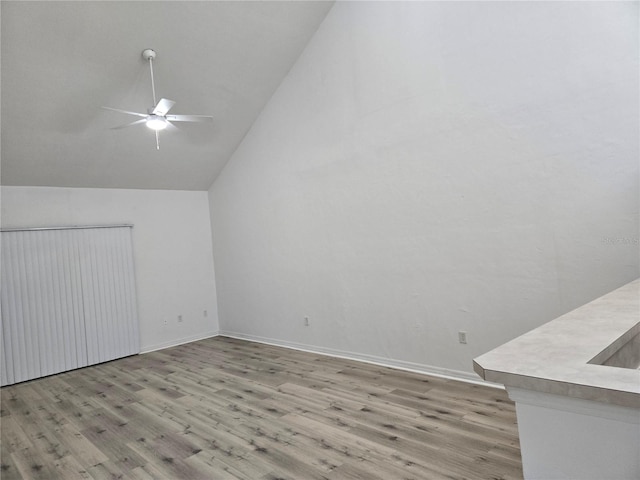 additional living space with lofted ceiling, ceiling fan, and light hardwood / wood-style flooring