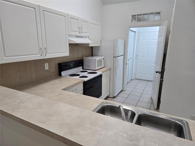 kitchen with white cabinetry, sink, light tile patterned floors, and white appliances