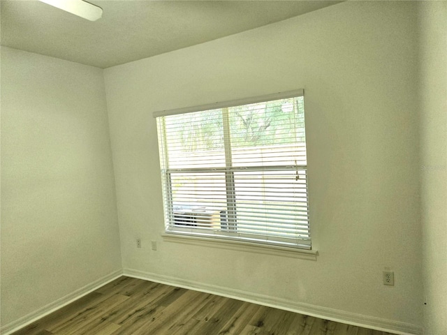 empty room with hardwood / wood-style floors