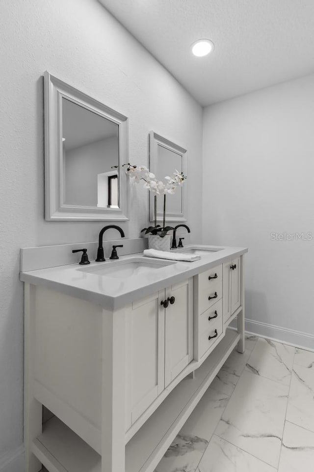 bathroom featuring vanity and a textured ceiling