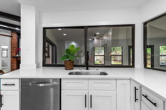 kitchen featuring white cabinets, sink, and dishwasher