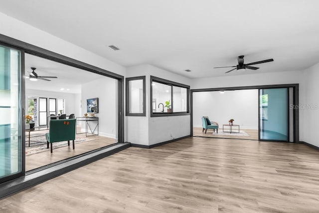 interior space with ceiling fan and light hardwood / wood-style floors