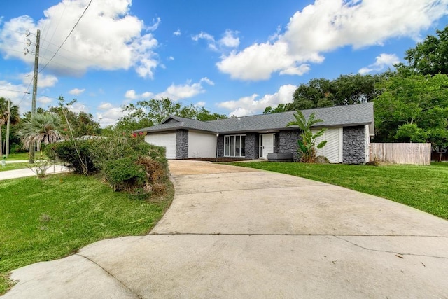 ranch-style home featuring a garage and a front lawn