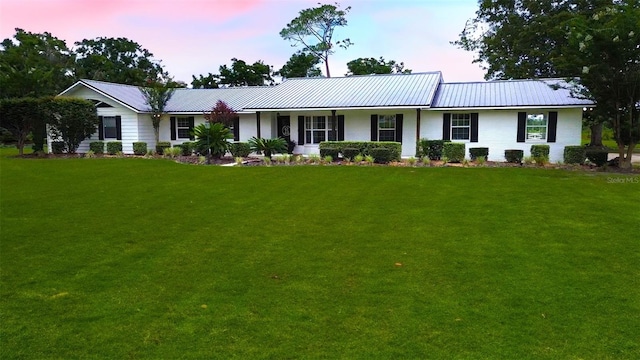 ranch-style house with a yard