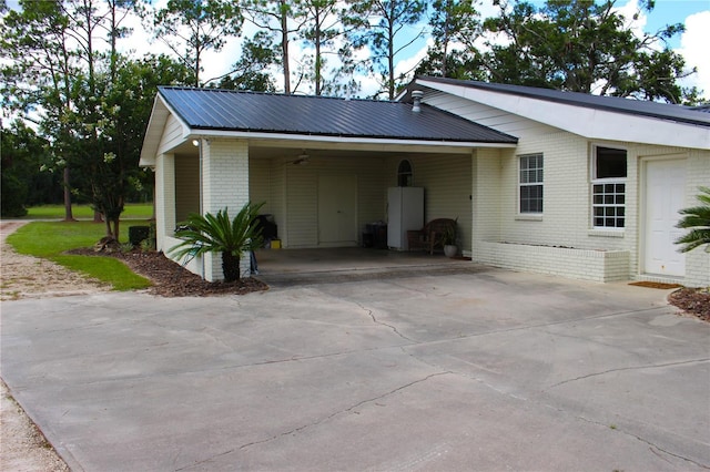 view of side of home with a carport