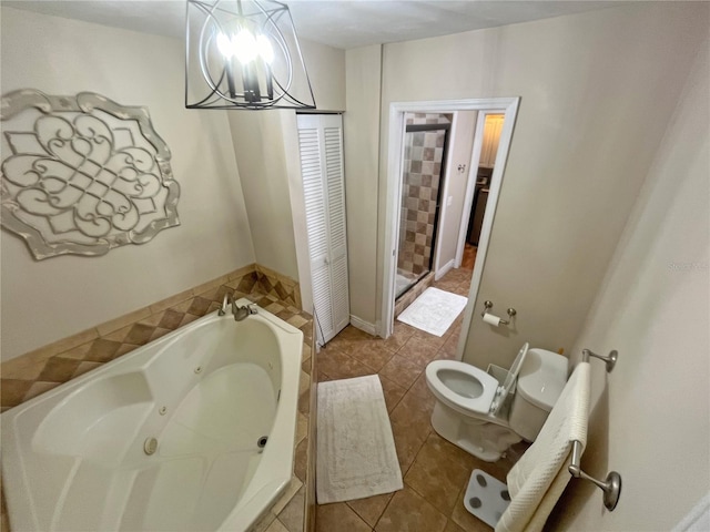 bathroom with an inviting chandelier, tile patterned floors, toilet, and tiled tub