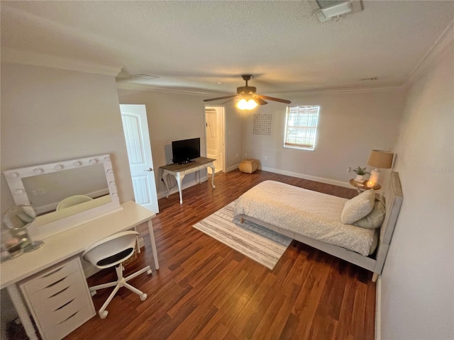 bedroom with dark wood-type flooring, ceiling fan, ornamental molding, and a textured ceiling