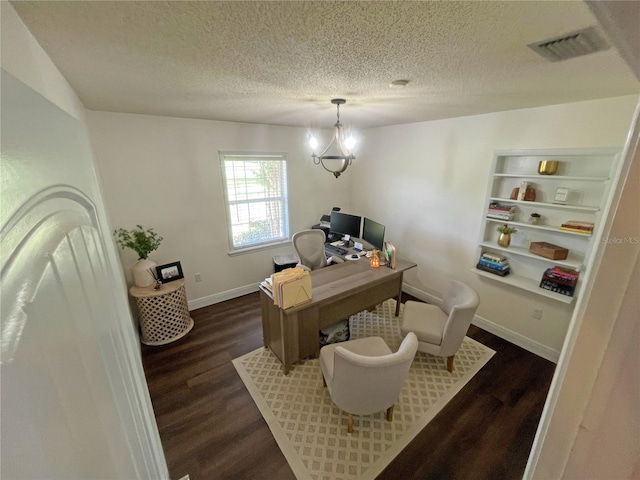 office area with a chandelier, a textured ceiling, and dark hardwood / wood-style flooring