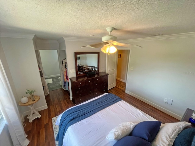 bedroom with ceiling fan, dark wood-type flooring, ornamental molding, and a textured ceiling