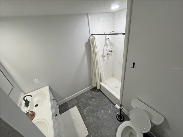 bathroom featuring vanity, toilet, and walk in shower