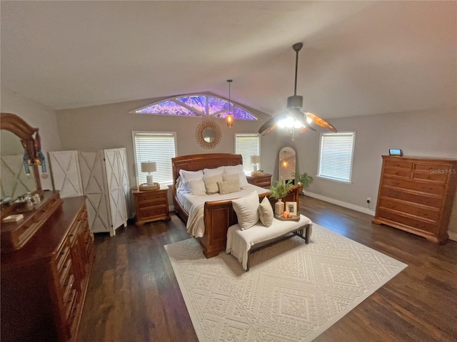 bedroom featuring ceiling fan, lofted ceiling, dark hardwood / wood-style floors, and multiple windows